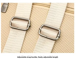 Detail of metal buckle and adjustable beige canvas shoulder strap on the backpack