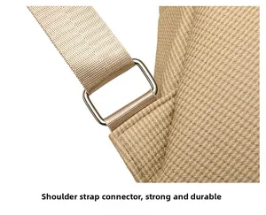 Close-up of reinforced shoulder strap stitching and metal ring on khaki backpack
