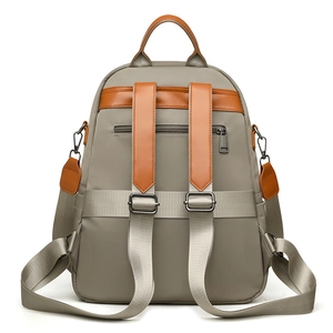 Large khaki nylon backpack with brown leather trim and hidden back zipper pocket
