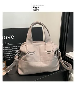 Detail view of light grey textured tote bag with detachable strap and U-shaped stitching