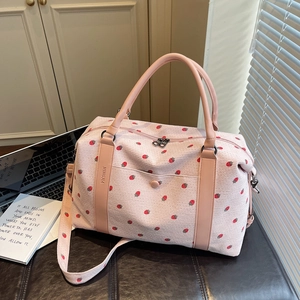 Pink strawberry print travel tote bag made of corduroy with leather handles and strap