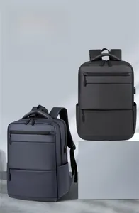 Detail view of business backpacks in black and navy showing waterproof fabric and zippers