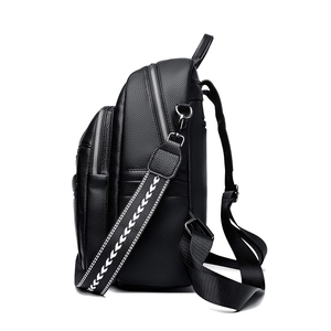 Large black pebbled leather backpack with multi-zipper layers and woven shoulder strap