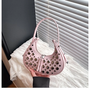 Detailed shot of pink crescent hobo bag with silver rivet studs and dual zip pullers
