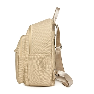 Mini champagne woven backpack featuring high-density nylon and metal zippers in side profile