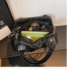 Interior view of large black leather tote bag showing spacious compartments and storage