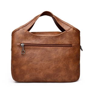 Minimalist caramel brown leather handbag with back zipper pocket and wide top handle