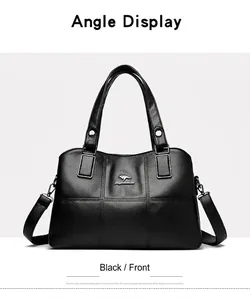 Close-up of black lychee grain leather bucket bag with silver metal logo and cross stitching