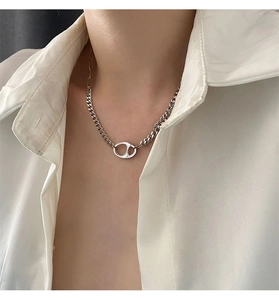 Détail du collier chaîne cubaine asymétrique avec pendentif en forme de grain de café