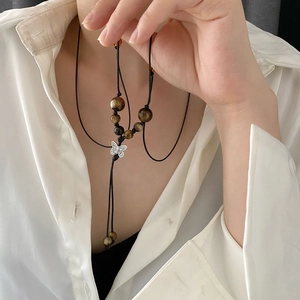 Handcrafted butterfly pendant necklace with tiger eye beads and black woven cord