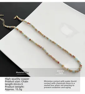 Detail of beaded necklace with blue natural stones, pearl and 42cm gold-plated chain