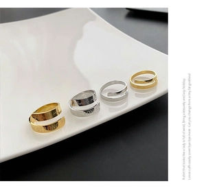 Detail view of gold and silver adjustable rings engraved with Stronger motivational text