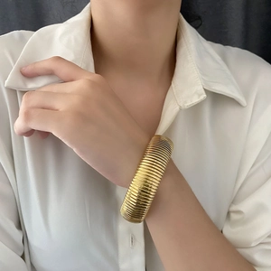 Exaggerated golden stainless steel wide bracelet with ribbed texture for women