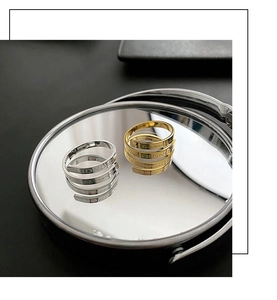 Macro detail of gold and silver spiral rings with Stronger engraving on mirror
