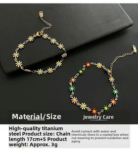 Detail of titanium steel daisy bracelet showing enamel flowers and adjustable chain size