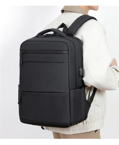 Side view of a black 15.6 inch laptop backpack with a built-in USB charging port