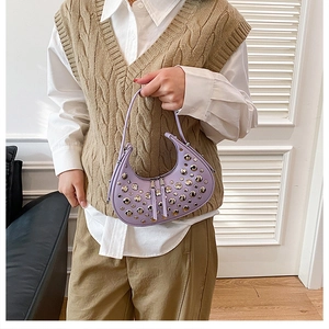 Detail of light purple crescent bag featuring silver metal rivets and thin handle