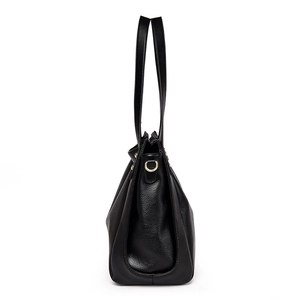 Side view of black lychee grain leather bucket bag with gold hardware and long straps