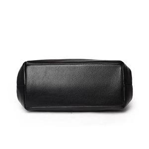 Bottom view of black pebble leather bucket bag with reinforced stitching and soft corners