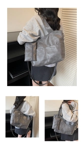 Detail of dark grey tote bag with lychee texture and matching small zipper pouch