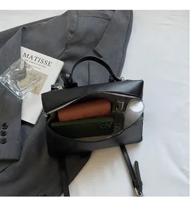 Interior view showing large capacity of the black leather crossbody bag for daily items