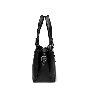 Chic black pebble leather bucket bag with silver metal ring and sleek side profile