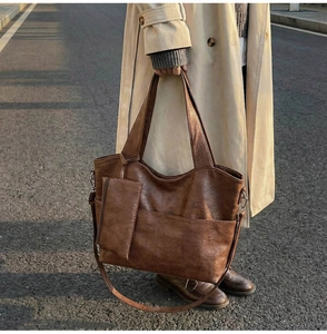 Detail of vintage brown large PU leather tote bag with a small matching coin purse