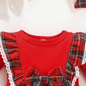 Detail of red ribbed knit dress with plaid ruffle sleeves and festive bow