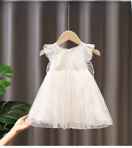 Close-up of white tulle girl dress with polka dots lace ruffles and mesh wings