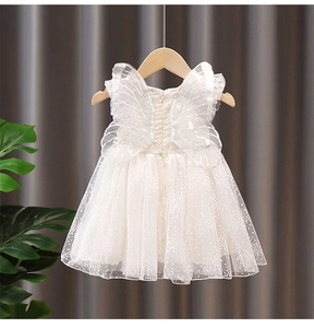 Detailed view of the layered organza dress with glitter dots and mesh fairy wings