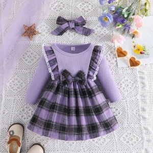 Detailed view of baby girl dress with purple ribbed knit top and plaid bow headband