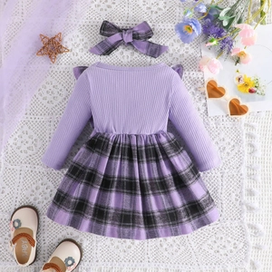 Flat lay of baby girl purple plaid dress set with matching headband and floral sandals