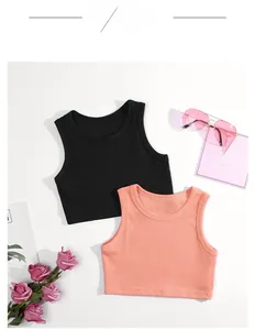 Close-up of ribbed cotton tank tops in black and coral pink for toddler girls