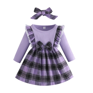 Close-up of baby girl plaid dress featuring purple knit bodice and 3-6M size tag details