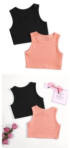 Close-up of ribbed knit texture on girls' sleeveless cotton vests in black and coral pink