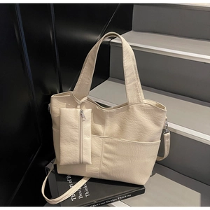 Detail of beige large tote bag in soft pleated PU leather with detachable coin purse