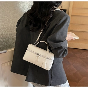 White faux leather box crossbody bag with dual silver zippers shown on a fashion model