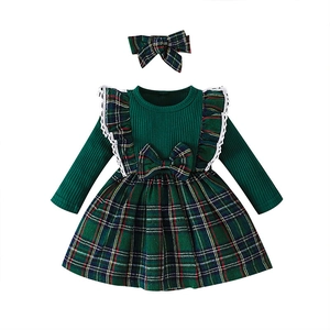 Detail of red and green plaid skirt with a waist bow and matching plaid headband set
