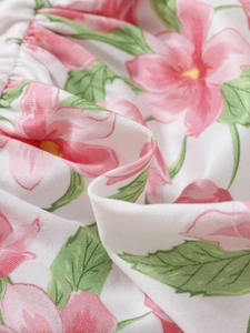 Close-up of pink flower print on high-quality fabric showing texture and soft material