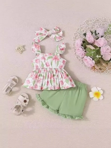 Toddler girl summer outfit set with floral camisole top and ruffle shorts on knit background