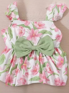 Baby girl floral sleeveless tank top and solid shorts set on a natural wood background