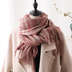 Detail of red and beige plaid scarf showing thick cashmere texture and fringe tassels