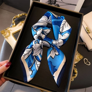 Blue and white floral silk scarf displayed elegantly in a luxury setting for women