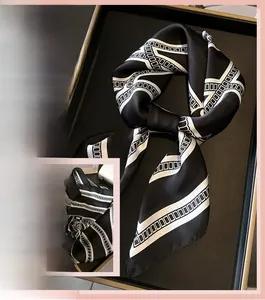 Detailed texture of French luxury chain print faux silk scarf with geometric pattern