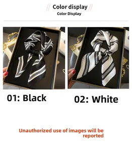 Detailed view of silk-like small square scarves with geometric chain patterns in black and white