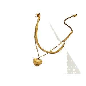 Double-layered gold titanium steel heart pendant necklace featuring a sleek snake chain