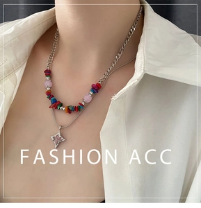 Close-up of double-layer beaded necklace with silver Cuban chain and star pendant