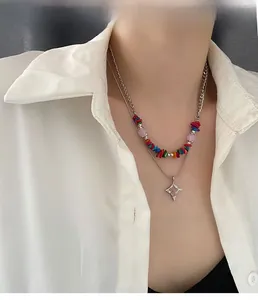Close-up of double-layered beaded necklace with colorful stones and star pendant on model