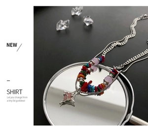 Close-up of double-layer beaded necklace with colorful stones and pink star pendant