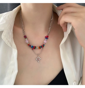 Detail of double-layer beaded necklace featuring colorful stones and a star pendant